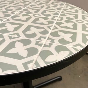 Round tile table top with steel edging.