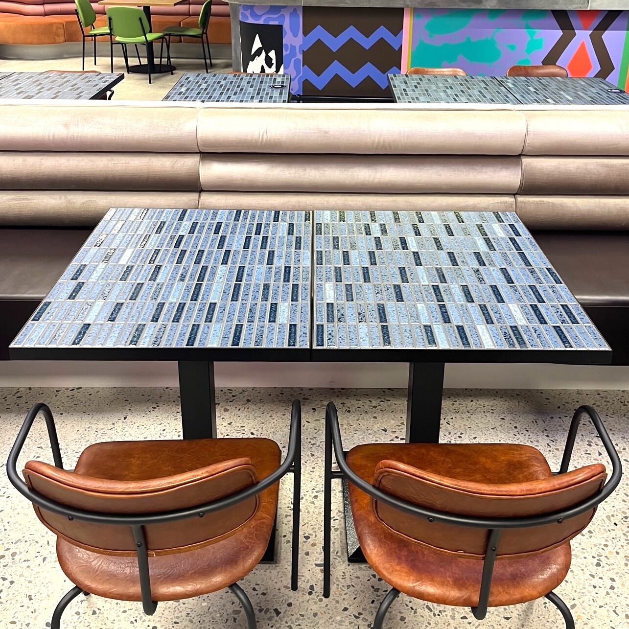 Tiled table top with steel edging are more durable and protect the tiled edges.
